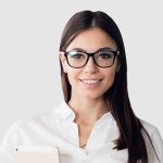 smiling-businesswoman-walking-along-the-office-cor